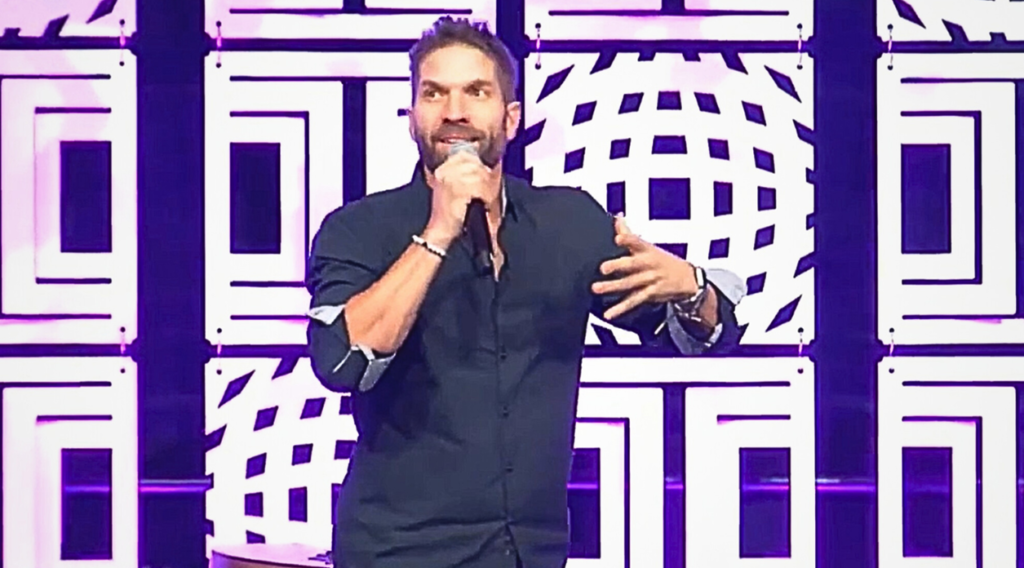 Rory Gardiner delivering a funny keynote at a corporate conference